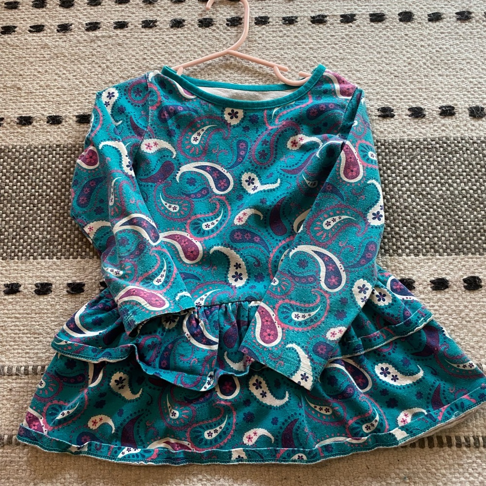 Long sleeved ruffled toddler top with Paisley print.